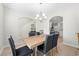 Elegant dining room with wood floors, chandelier, and view to the kitchen at 461 Charleston Pl, Villa Rica, GA 30180