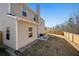 Exterior side view of home featuring backyard, patio with furniture, and wooden fence enhancing privacy at 461 Charleston Pl, Villa Rica, GA 30180