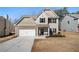 Charming two-story home featuring stone accents, neutral siding, and an attached two-car garage at 461 Charleston Pl, Villa Rica, GA 30180