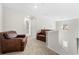 Upstairs hallway landing with comfy leather chairs and a view of the staircase at 461 Charleston Pl, Villa Rica, GA 30180