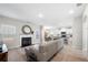 Bright living room with fireplace, wood flooring, and open to the kitchen at 461 Charleston Pl, Villa Rica, GA 30180