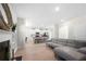 Open-concept living room with wood flooring, fireplace, and view to the kitchen at 461 Charleston Pl, Villa Rica, GA 30180