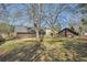 Expansive backyard featuring mature trees, a storage shed, and a wooden fence at 4722 Bexley Dr, Stone Mountain, GA 30083