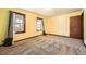 Sunny bedroom features yellow walls, carpeting, two windows and natural light at 4722 Bexley Dr, Stone Mountain, GA 30083