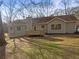 Rear exterior of home showing siding, brick foundation and back deck at 521 Country Lake Dr, Mcdonough, GA 30252