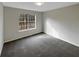 Bright, carpeted bedroom with a large window at 521 Country Lake Dr, Mcdonough, GA 30252