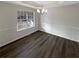 Elegant dining room featuring modern lighting, trim, and wood floors at 521 Country Lake Dr, Mcdonough, GA 30252
