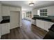 Open kitchen with white cabinetry, black countertops, stainless steel appliances, and modern backsplash at 521 Country Lake Dr, Mcdonough, GA 30252