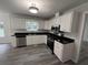 Modern kitchen with white cabinets, stainless steel appliances and granite countertops at 521 Country Lake Dr, Mcdonough, GA 30252