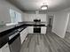 Modern kitchen with white cabinets, stainless steel appliances, and dark countertops at 521 Country Lake Dr, Mcdonough, GA 30252