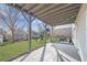 Covered back patio overlooking a lush green lawn and landscaped backyard with a playground at 667 Creswell Park, Smyrna, GA 30082