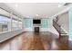 Inviting living room featuring hardwood floors, a cozy fireplace, built-in shelving, and large windows for natural light at 667 Creswell Park, Smyrna, GA 30082