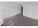 Neutral toned bedroom with carpet flooring and double door closet at 212 Riverstone Commons Cir, Canton, GA 30114