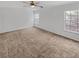 Spacious bedroom with carpet, a ceiling fan, and plenty of natural light from the three well placed windows at 212 Riverstone Commons Cir, Canton, GA 30114