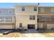 Rear view of a townhome with a driveway, balcony, and garage at 212 Riverstone Commons Cir, Canton, GA 30114