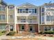 Inviting townhome showcases brick and siding exterior with balcony and landscaping at 212 Riverstone Commons Cir, Canton, GA 30114