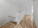 Hallway with wood-look flooring, neutral walls, and natural light at 212 Riverstone Commons Cir, Canton, GA 30114