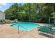 Enjoy the sparkling community pool surrounded by lush landscaping and comfortable lounge chairs at 212 Riverstone Commons Cir, Canton, GA 30114