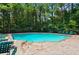 Enjoy the sparkling community pool surrounded by lush landscaping and comfortable lounge chairs at 212 Riverstone Commons Cir, Canton, GA 30114