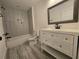 Modern bathroom featuring a stylish vanity with white countertops and a tiled shower-tub combination at 2173 Montrose Sw Ave, Atlanta, GA 30311