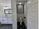Renovated half bathroom with marble floors and modern fixtures at 2173 Montrose Sw Ave, Atlanta, GA 30311