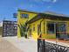 Vibrant yellow building featuring a plant-based juice and smoothie bar, with artistic murals and a modern design at 2173 Montrose Sw Ave, Atlanta, GA 30311
