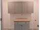 Well-appointed laundry room featuring stylish grey cabinets and a functional, light wood countertop at 2173 Montrose Sw Ave, Atlanta, GA 30311