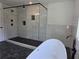 Contemporary shower with black marble flooring and white subway tile at 2173 Montrose Sw Ave, Atlanta, GA 30311