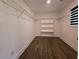 Walk-in closet with custom shelving and hardwood floors at 2173 Montrose Sw Ave, Atlanta, GA 30311