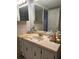 Bathroom featuring a vanity with cabinetry, a large mirror, and toiletries at 3530 Piedmont Ne Rd # I3, Atlanta, GA 30305