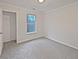 Bright, empty bedroom with neutral carpet, a closet and a window at 483 Fairlane Nw Cir, Atlanta, GA 30331