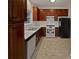 Classic kitchen featuring ample wood cabinets, white appliances, and tile backsplash at 483 Fairlane Nw Cir, Atlanta, GA 30331