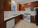 Well-lit kitchen with stainless steel appliances, wood cabinets, and white countertops at 483 Fairlane Nw Cir, Atlanta, GA 30331