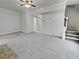 Open-concept living room with ceiling fan and adjacent staircase at 483 Fairlane Nw Cir, Atlanta, GA 30331