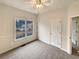 Carpeted bedroom with neutral paint, large window, baseboard and chair rail molding, and a ceiling fan at 4905 Ascot Nw Blf, Acworth, GA 30102