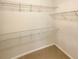 Walk-in closet with built-in metal shelving for optimal storage and organization at 4905 Ascot Nw Blf, Acworth, GA 30102