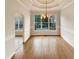 Elegant dining room featuring wood floors, large window overlooking the pool, and a decorative light fixture at 4905 Ascot Nw Blf, Acworth, GA 30102