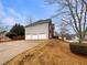 View of the house with a three car garage and a long driveway at 4905 Ascot Nw Blf, Acworth, GA 30102