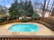 Backyard pool surrounded by trees and a wood fence at 4905 Ascot Nw Blf, Acworth, GA 30102