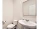 Modern half-bathroom with a pedestal sink and toilet at 4929 Dufour Dr, Lilburn, GA 30047