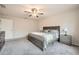 A neutral bedroom is furnished with gray wood furniture and plush gray carpet at 4929 Dufour Dr, Lilburn, GA 30047