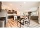 Bright dining area connected to the kitchen and living room, featuring modern finishes and wood-look floors at 4929 Dufour Dr, Lilburn, GA 30047