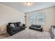 Bright living room with plush seating, including a love seat, cozy carpet, and a large window at 4929 Dufour Dr, Lilburn, GA 30047