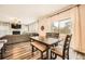 Bright living room and dining area with hardwood floors, fireplace, and sliding glass door to the backyard at 4929 Dufour Dr, Lilburn, GA 30047