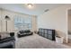 Cozy living room featuring plush carpet, natural light from two windows and comfortable seating at 4929 Dufour Dr, Lilburn, GA 30047