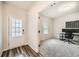 Bright home office featuring a desk setup, plush gray carpeting, and a view of the front door at 4929 Dufour Dr, Lilburn, GA 30047