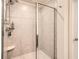 Modern shower with tiled walls, glass door, and a built-in niche for toiletries at 4929 Dufour Dr, Lilburn, GA 30047