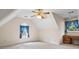Bright bedroom with vaulted ceiling and dormer windows featuring blue accents and built-in desk at 10625 Haynes Forest Dr, Alpharetta, GA 30022