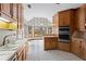Bright kitchen featuring stainless steel appliances, wood cabinets, and a view to the breakfast nook at 10625 Haynes Forest Dr, Alpharetta, GA 30022