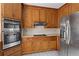 Well-equipped kitchen featuring stainless steel appliances and ample wooden cabinet space at 10625 Haynes Forest Dr, Alpharetta, GA 30022